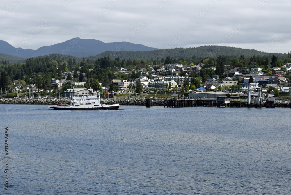 view across the ocean towards the harbour in  Powell River with the ferry arriving, British Columbia Canada