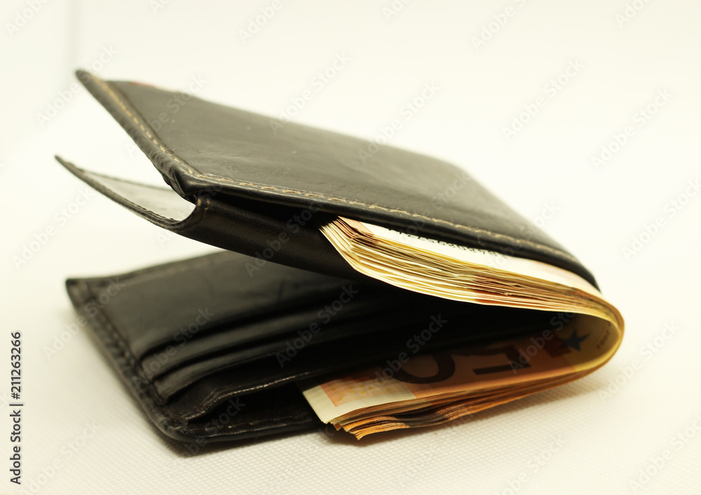 Money in your wallet. Denominations look out of the purse. Paper euros. Money in your wallet. Denominations look out of the purse. Paper euros.