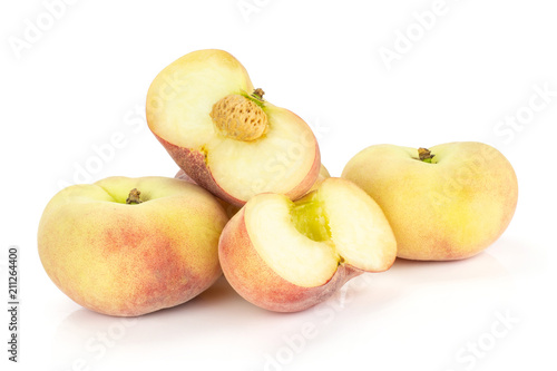Fresh ripe Saturn peaches and two sliced halves isolated on white background.