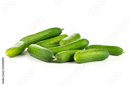 Fresh green mini cucumbers heap isolated on white background.