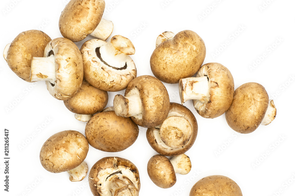 Fresh raw brown champignons flatlay isolated on white background. Fresh raw brown champignons flatlay isolated on white background.