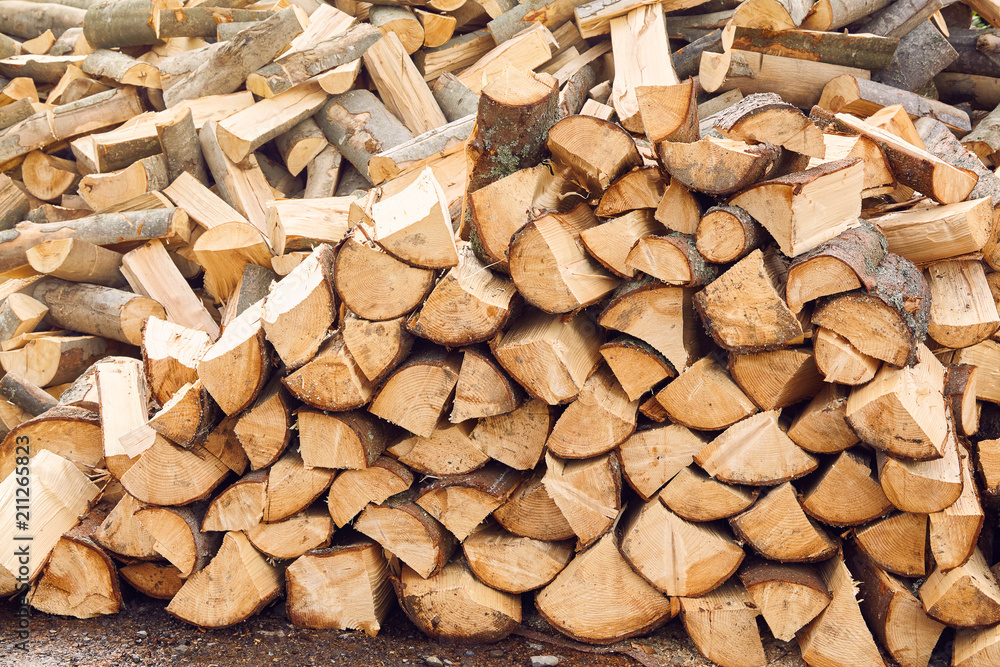 Stacks of firewood in the sawmill. Pile of firewood. Firewood background Stacks of firewood in the sawmill. Pile of firewood. Firewood background