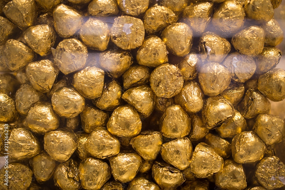 Chocolate candies in gold foil close-up Chocolate candies in gold foil close-up