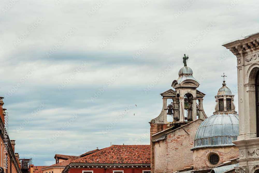 Cloudy sky above Rialto Market Square in Venice with old Church of San Giacomo belfry and dome (with copy space)