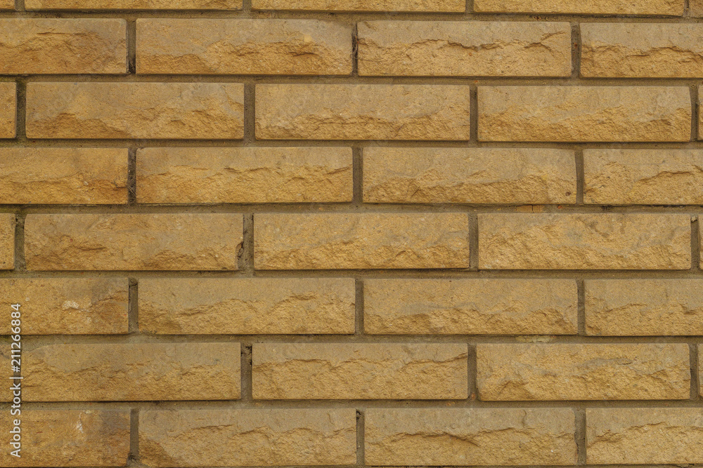 Obraz premium Background of a wall made of bricks made of sandstone texture