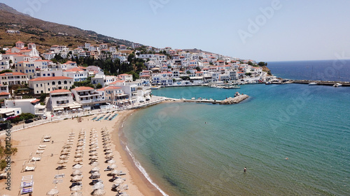 Fototapeta Naklejka Na Ścianę i Meble -  Aerial drone bird's eye view of picturesque village of Batsi with traditional taverns and clear water beach, Andros island, Cyclades, Greece
