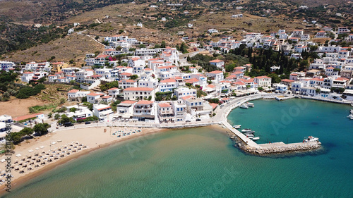 Aerial drone bird's eye view of picturesque village of Batsi with traditional taverns and clear water beach, Andros island, Cyclades, Greece photo