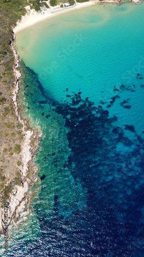 Aerial drone bird's eye view photo of famous turquoise water sandy beach of Psili Amos near port of Gavrio, Andros island, Cyclades, Greece