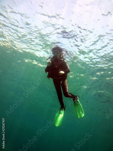 Underwater photo of scuba diver in popular beach of Sounion, Athens riviera, Attica, Greece