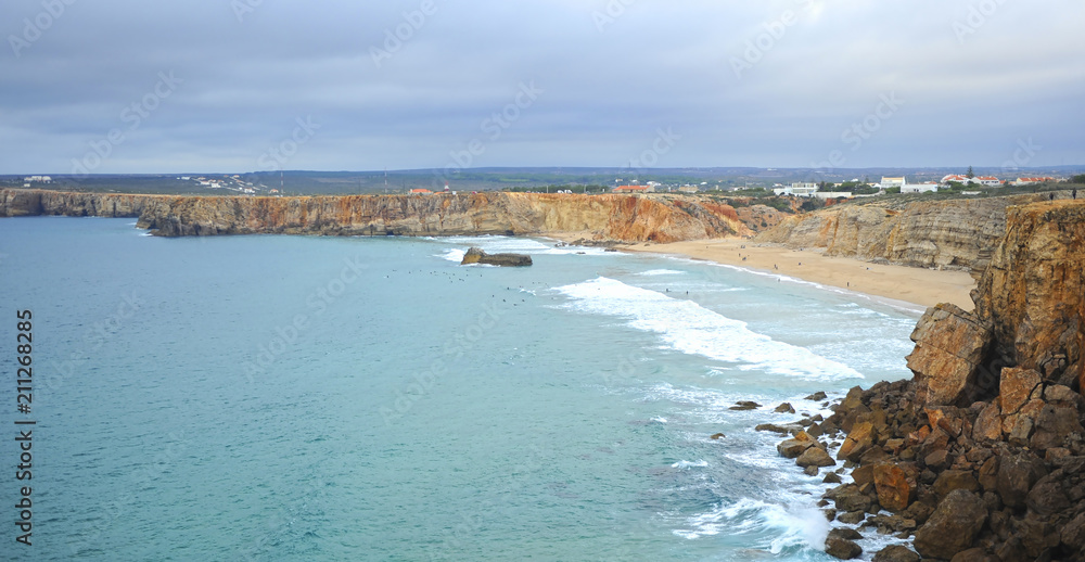 Surfers in Tonel beach of Sagres. Bathed by the Atlantic Ocean is one of the most visited by European tourism. Algarve, south of Portugal.