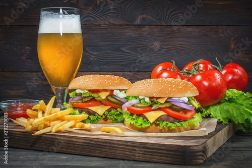 Hamburger and light beer on a pub background.