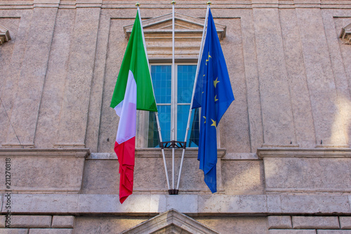 two flags Italian and European Union on old building in rome italy 