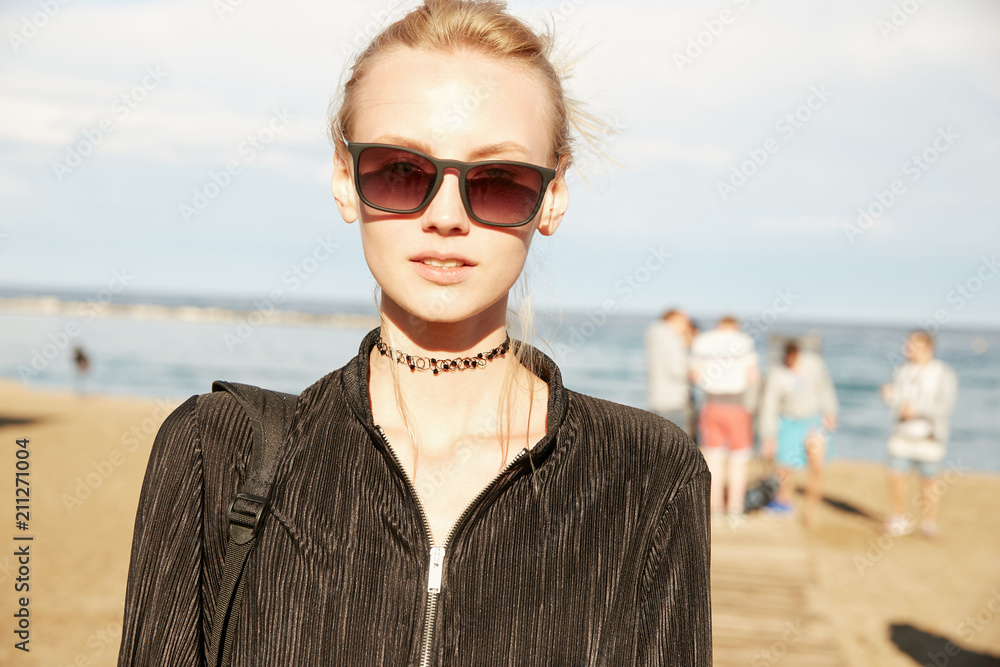 Portrait of a blonde model girl on the beach with wind in her hair Portrait of a blonde model girl on the beach with wind in her hair