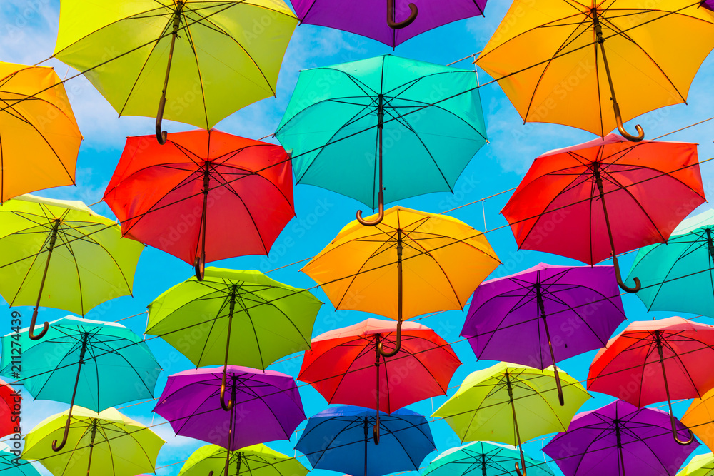 Colorful umbrellas background. Multi-colored umbrellas in the sky. Street decoration.