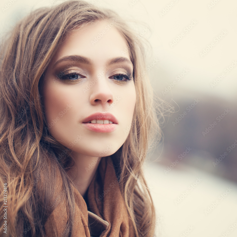 Fototapeta premium Cute girl outdoors in park. Perfect female face closeup