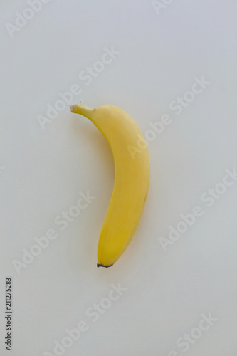 banana on pastel gray paper, trendy background. fruit flat lay, juicy vitamin abstract background, pop art style. modern image