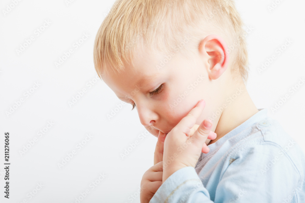 Boy licking something good from fingers Boy licking something good from fingers