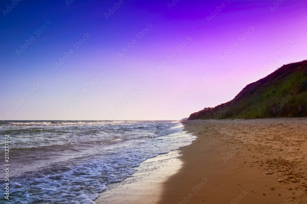 Fototapeta premium yellow sand beach near the blue beautiful sea