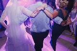 bride and groom having fun and dancing at wedding reception. holiday celebrations. people dance at party in restaurant