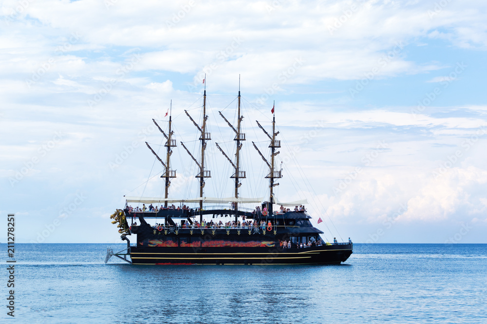Sea with tourist sightseeing ship in the bay, coast of the Mediterranean Sea. Sea with tourist sightseeing ship in the bay, coast of the Mediterranean Sea.