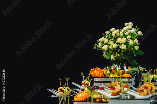 Fourchette snacks and flowers isolated on a black background
