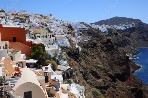 Famous stunning view of white architectures and colors above the volcanic caldera in the village of Oia in Santorini island, Greece