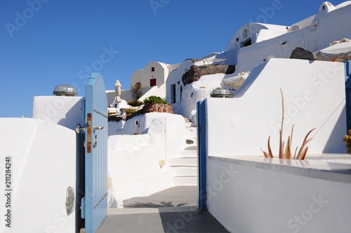 Famous stunning view of white architectures and colors above the volcanic caldera in the village of Oia in Santorini island, Greece