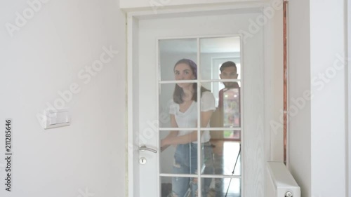Two people entering their new living room