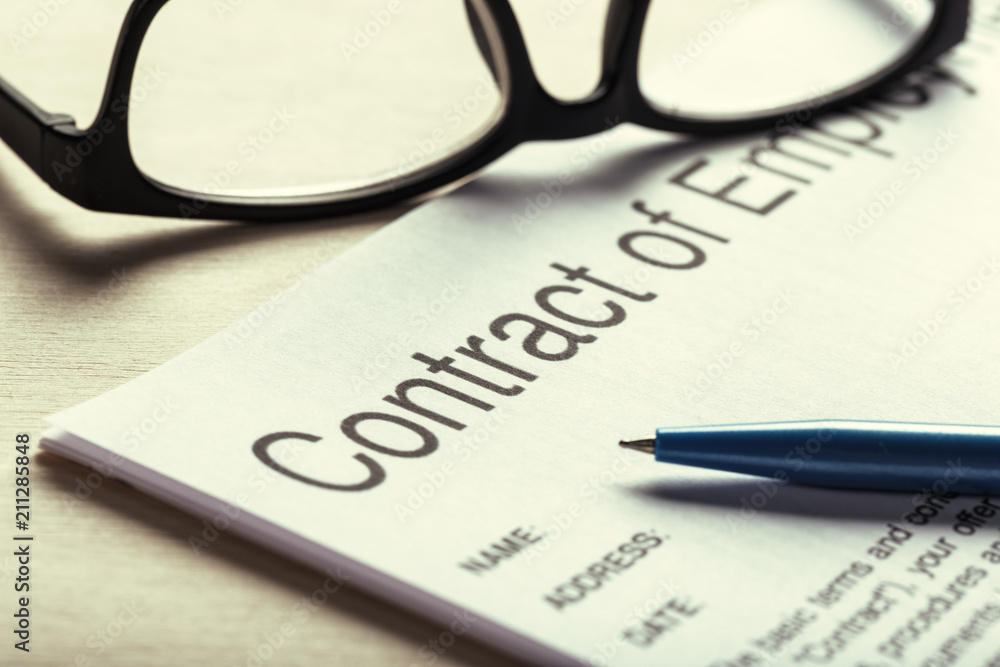 Close up shot of Eyeglasses on contract document papers business concept Close up shot of Eyeglasses on contract document papers business concept