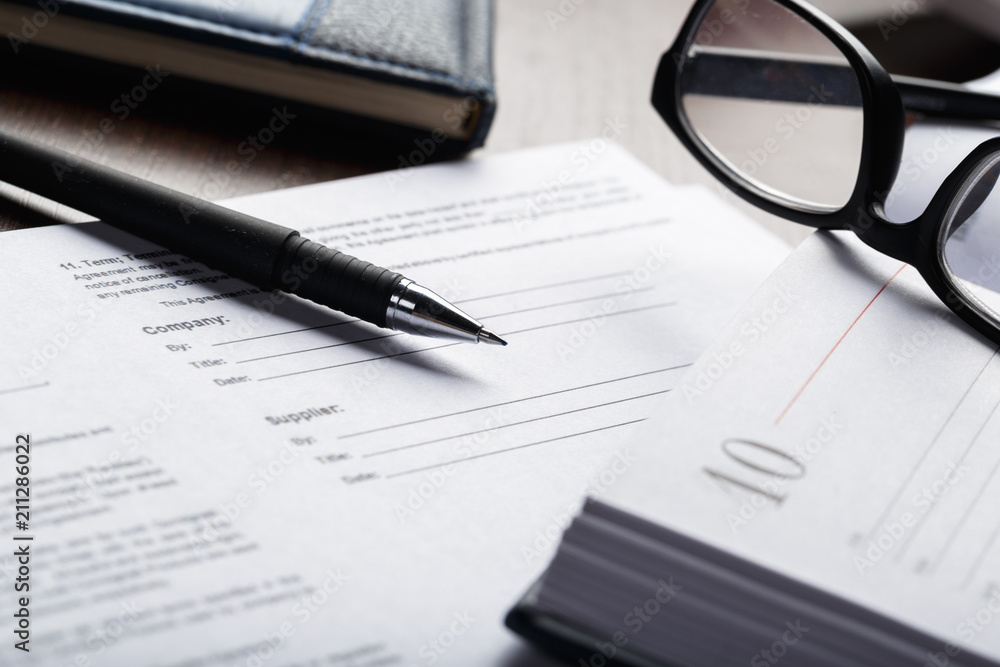 Close up shot of Eyeglasses on document papers business concept Close up shot of Eyeglasses on document papers business concept