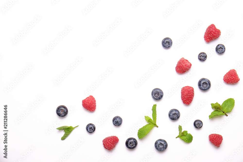 Bunch of fresh organic mixed berries, blueberry, raspberry & mint in seamless pattern, white background. Clean eating concept. Healthy vegan snack, raw diet. Close up, copy space, top view, flat lay. Bunch of fresh organic mixed berries, blueberry, raspberry & mint in seamless pattern, white background. Clean eating concept. Healthy vegan snack, raw diet. Close up, copy space, top view, flat lay.