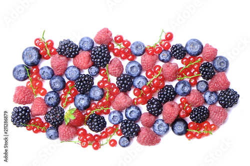 Bunch of mixed berries in harvest pile on white background. Colorful composition with fresh organic strawberry  blueberry  blackberry   redcurrant. Clean eating concept. Close up  copy space  top view