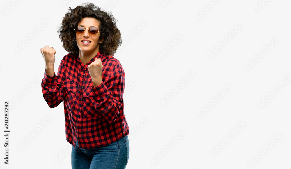 Beautiful arab woman happy and excited celebrating victory expressing big success, power, energy and positive emotions. Celebrates new job joyful Beautiful arab woman happy and excited celebrating victory expressing big success, power, energy and positive emotions. Celebrates new job joyful
