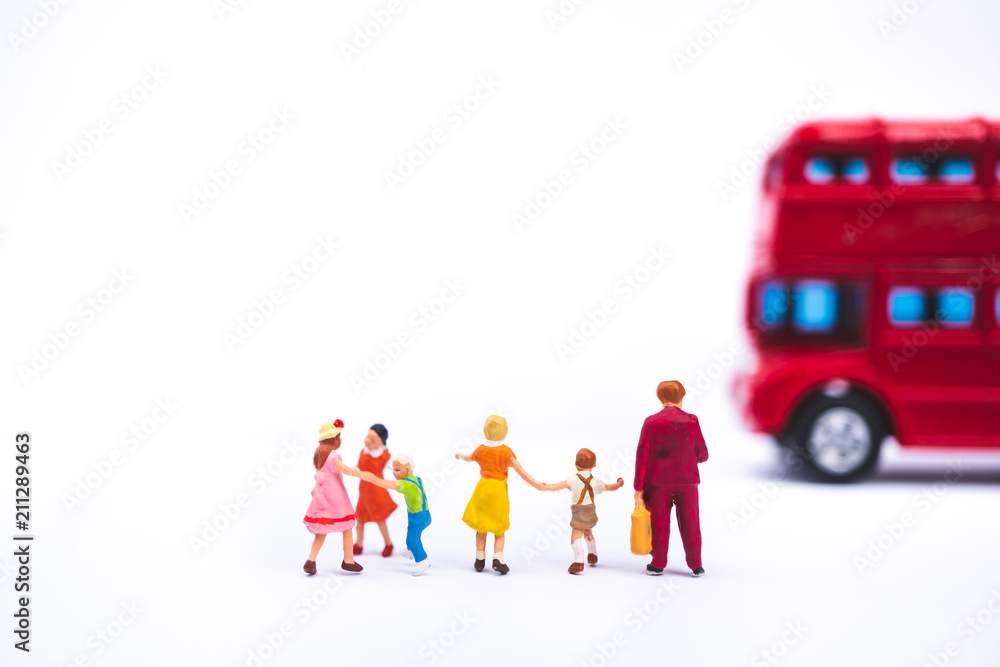 Miniature people, mother and children waiting bus using as family and education concept Miniature people, mother and children waiting bus using as family and education concept