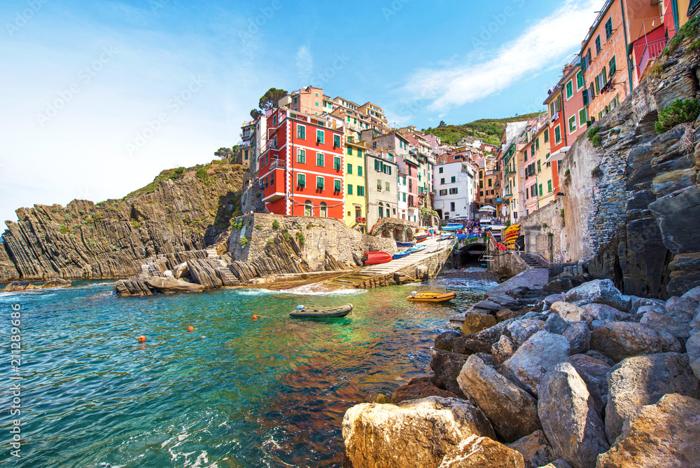 Incredible landscape with rocks on the coast of Riomaggiore in Cinque Terre, Liguria, Italy, Europe in sunshine
