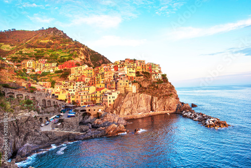 Charming beautiful landscape with bright colored houses on the rock on the seafront of Manarola in Cinque Terre, Liguria, Italy, Europe at sunset