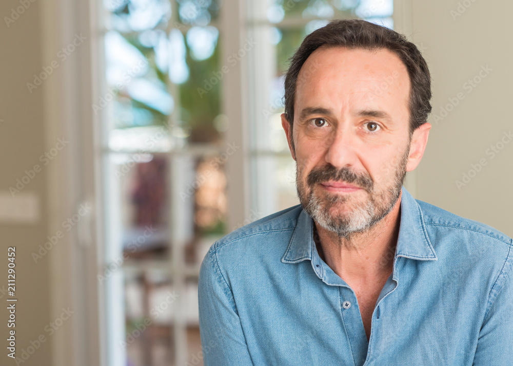 Handsome middle age man with a confident expression on smart face thinking serious Handsome middle age man with a confident expression on smart face thinking serious