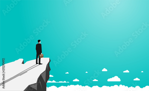 Businessman standing on the cliff