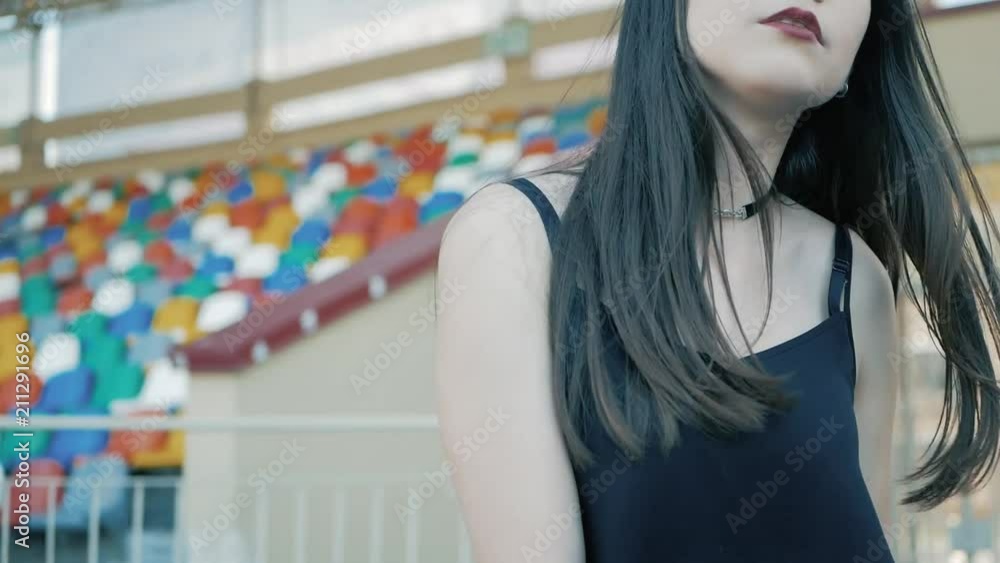 cool fashion serious teenage woman wearing in black, leather jacket, choker necklace with a long dark hair and lipstick cool fashion serious teenage woman wearing in black, leather jacket, choker necklace with a long dark hair and lipstick