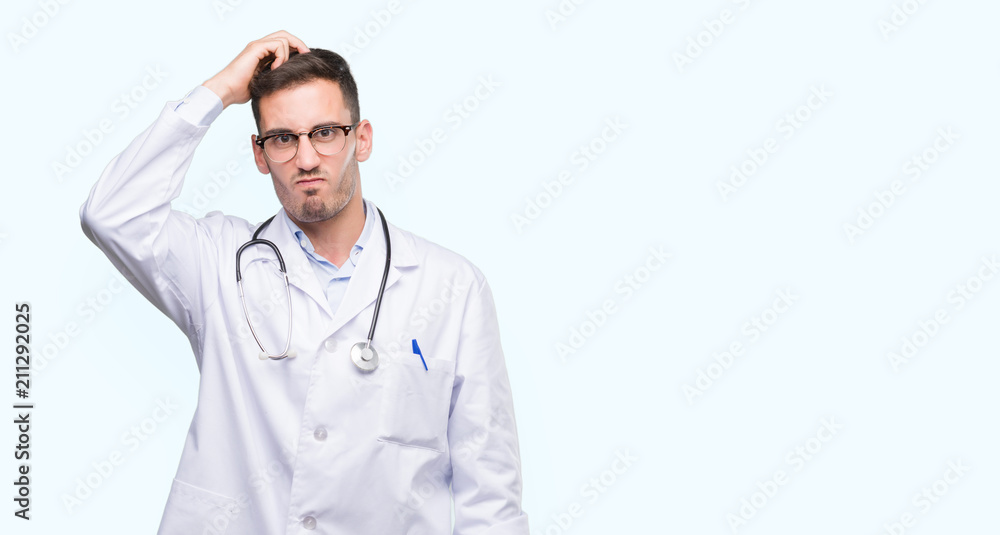 Handsome young doctor man confuse and wonder about question. Uncertain with doubt, thinking with hand on head. Pensive concept. Handsome young doctor man confuse and wonder about question. Uncertain with doubt, thinking with hand on head. Pensive concept.