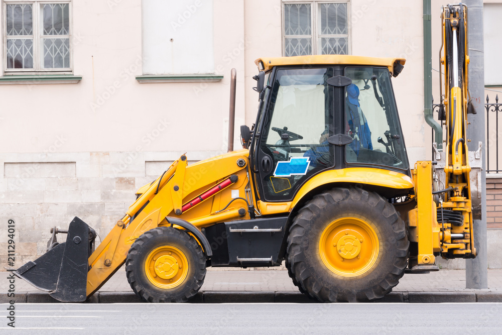 the yellow bulldozer stands at the old building the yellow bulldozer stands at the old building