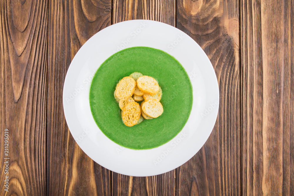 vegetarian food - spinach soup cream, top view, on a wooden background vegetarian food - spinach soup cream, top view, on a wooden background