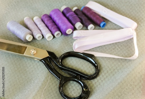 Sewing threads, satin ribbons and the tailor's scissors