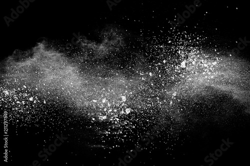 Bizarre forms of white powder explosion cloud against dark background. Launched white particle splash on black background
