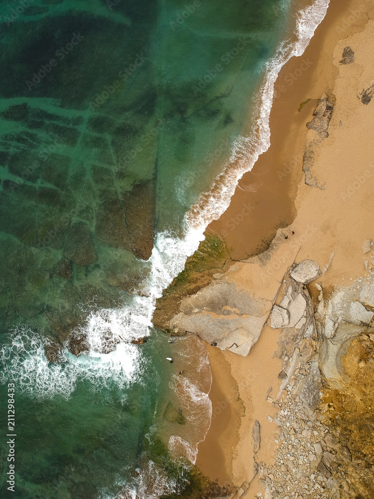 surfer on the beach top view. Drone shot on a beach in a summer day. surfer on the beach top view. Drone shot on a beach in a summer day.