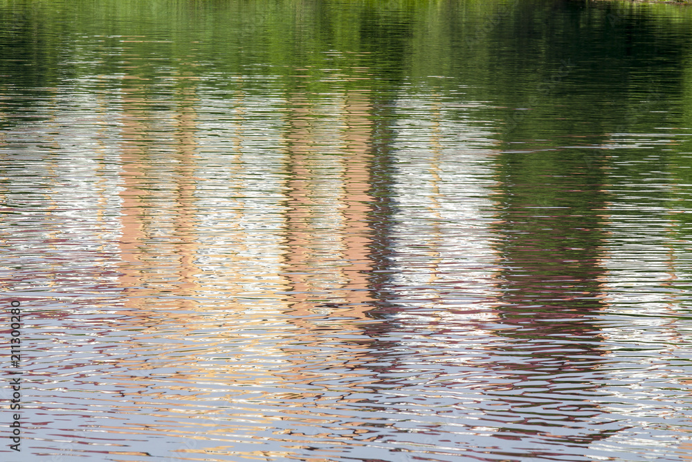 Reflection of a brick building on the lake as an abstract background