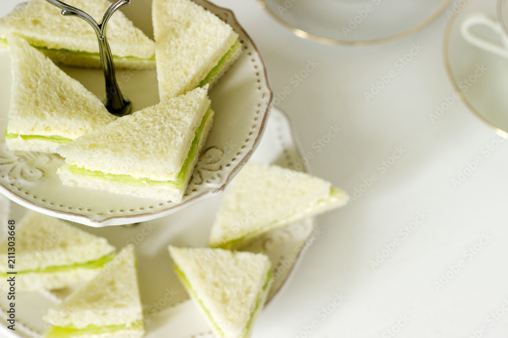 Triangular sandwiches with cucumber and butter for a tea party, English tradition.