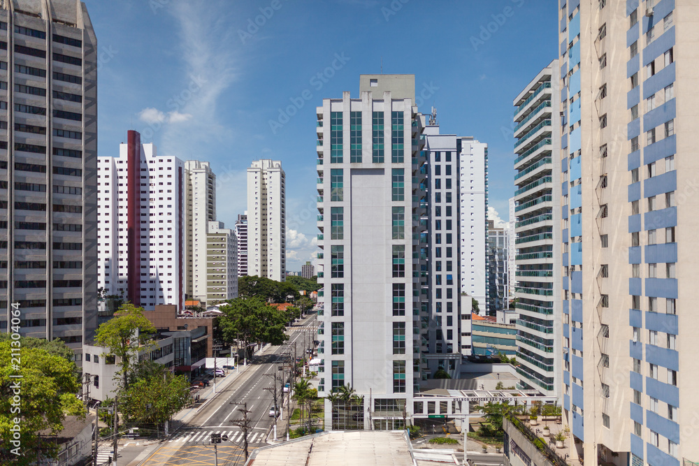 View on main road with tall buildings in neighbourhood View on main road with tall buildings in neighbourhood
