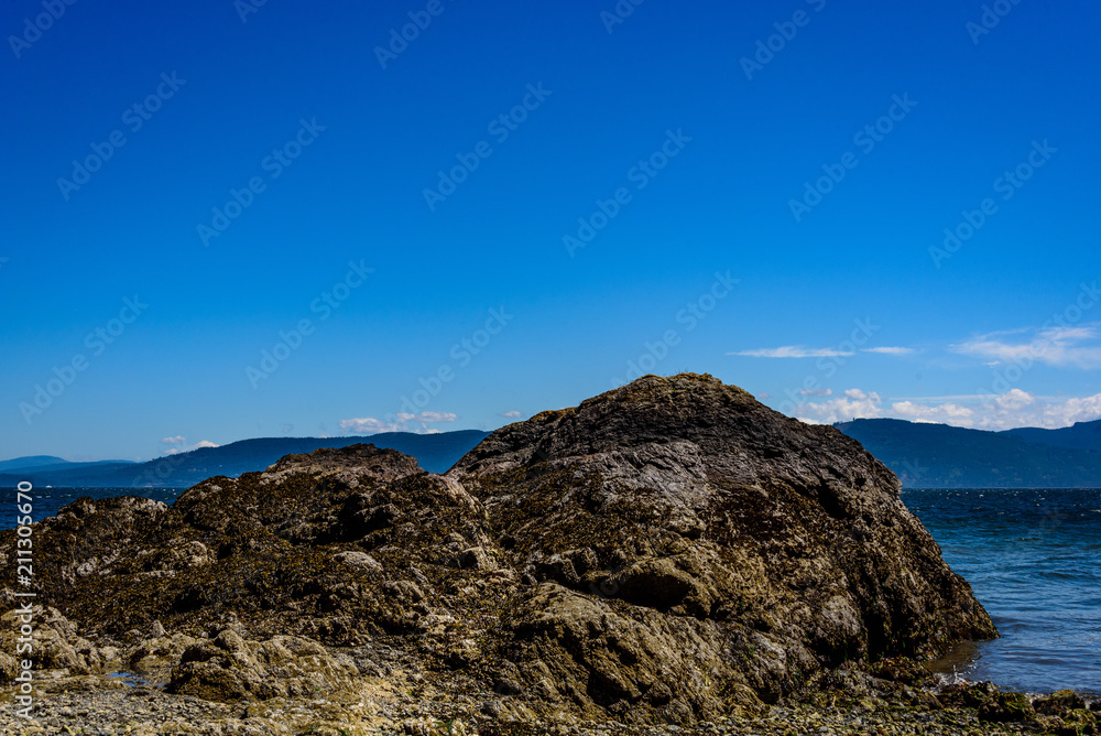 Rock formation on a beach in the San Juan Islands, the Salish Sea and other islands in the background, sunny day with a blue sky and while clouds
Rock formation on a beach in the San Juan Islands, the Salish Sea and other islands in the background, sunny day with a blue sky and while clouds