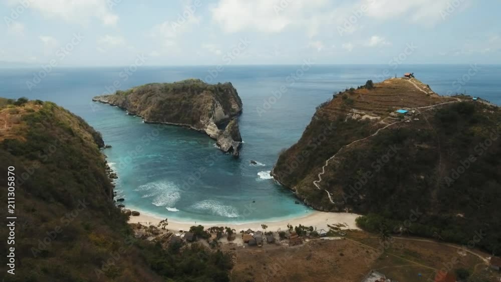 Aerial view of beautiful white sand Atuh beach for relax. Clear blue ocean waves rolling to the beach. Nusa Penida, Bali, Indonesia. Travel concept. Aerial footage. Aerial view of beautiful white sand Atuh beach for relax. Clear blue ocean waves rolling to the beach. Nusa Penida, Bali, Indonesia. Travel concept. Aerial footage.